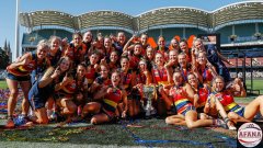 Adelaide players with 2022 AFLW premiership cup