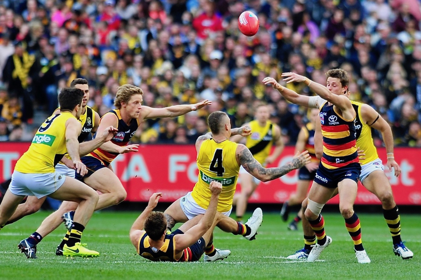 Brad Crouch tackles Dusty as brother Matt and Sloane reach for the sherrin. Photo by Kim Densham for AFANA.