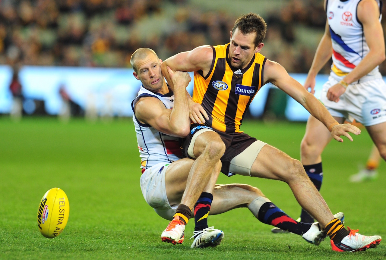 Hawthorn's Luke Hodge Hodge gets trapped by Thompson of the Crows. Photo by Kiim Densham for AFANA.