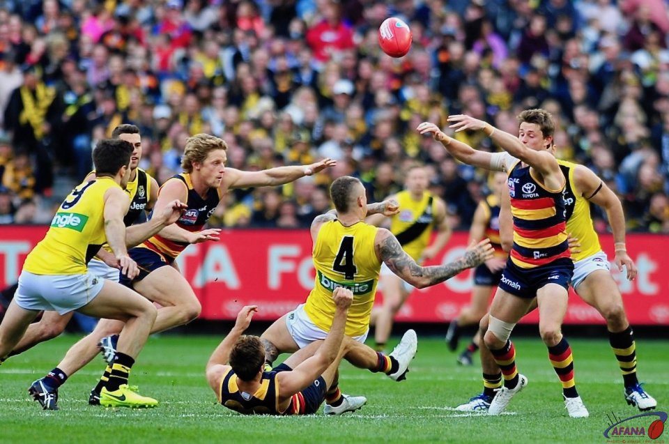 Brad Crouch tackles Dusty as brother Matt and Sloane reach for the sherrin