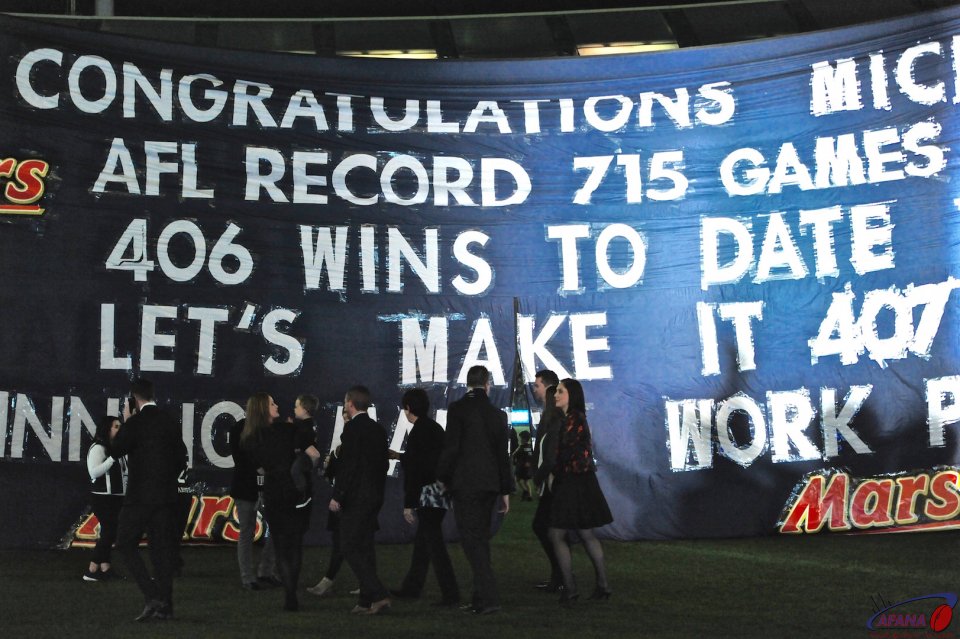 Michael Malthouse walks to the Blues banner prior to his record breaking game