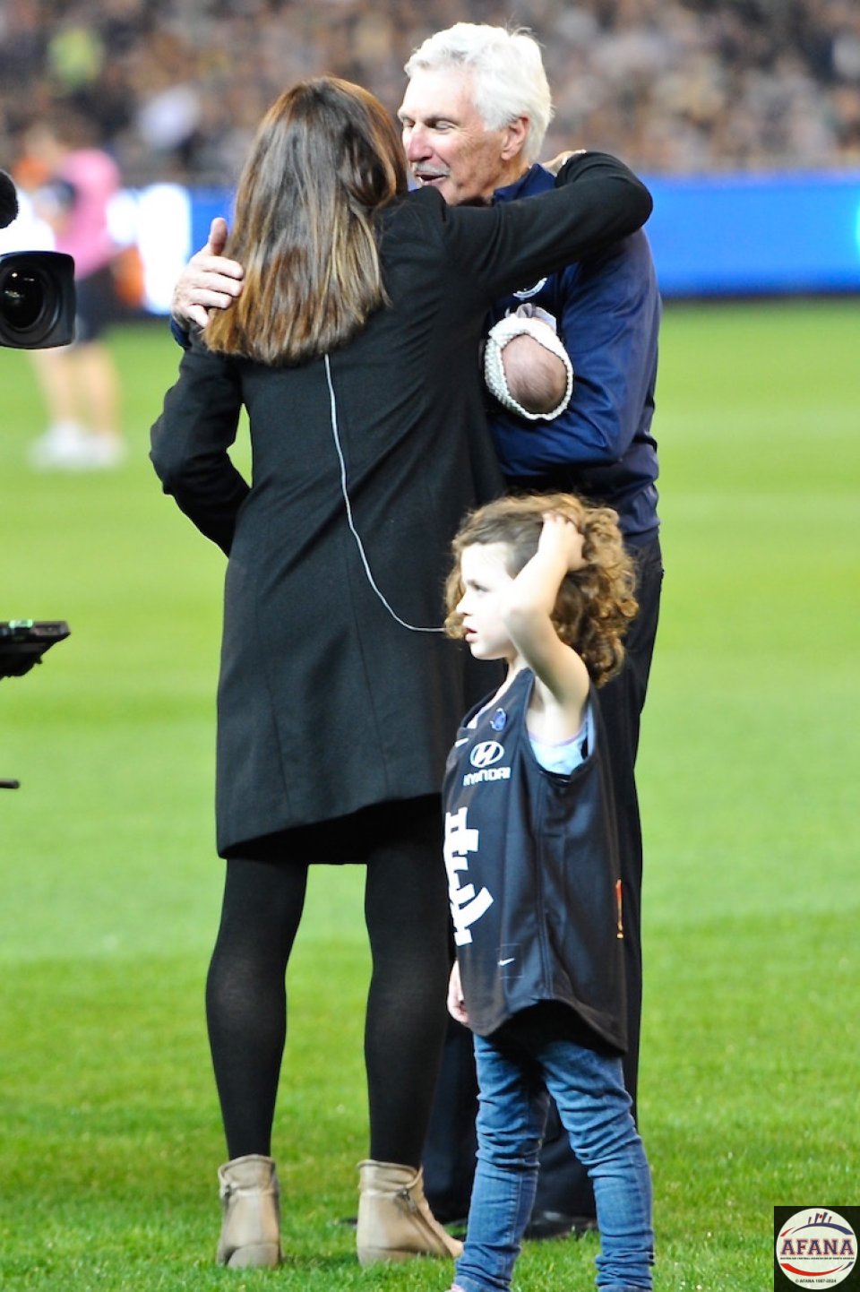 Christy Malthouse gets a hug from Dad