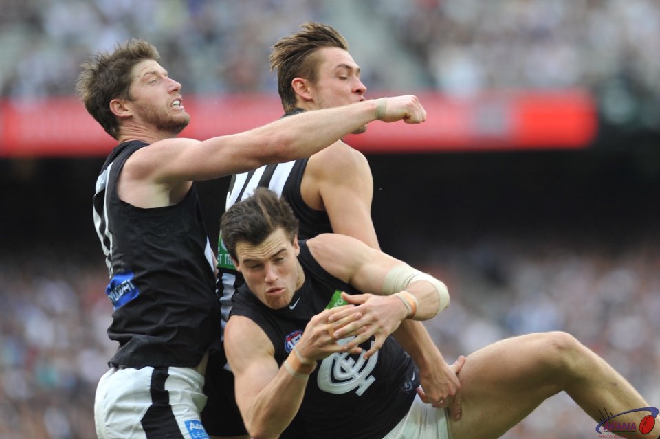 Sam Rowe whistles a fist away just past Darcy Moore's head