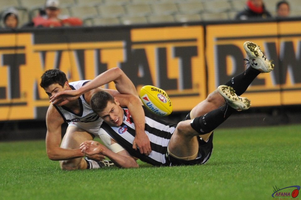 Mason Cox is tackled by Sam Collins
