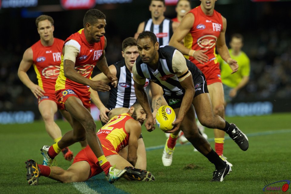 Travis Varcoe clears the ball in as Adam Saad and Touk Miller contest