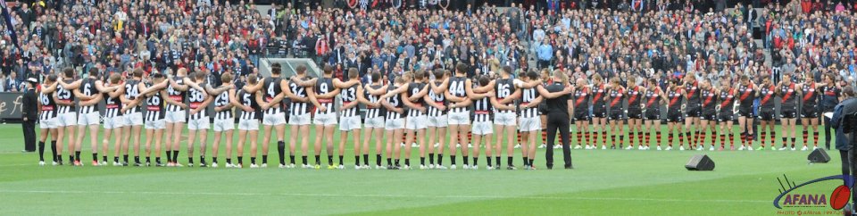 Essendon and Collingwood teams in the ANZAC line up