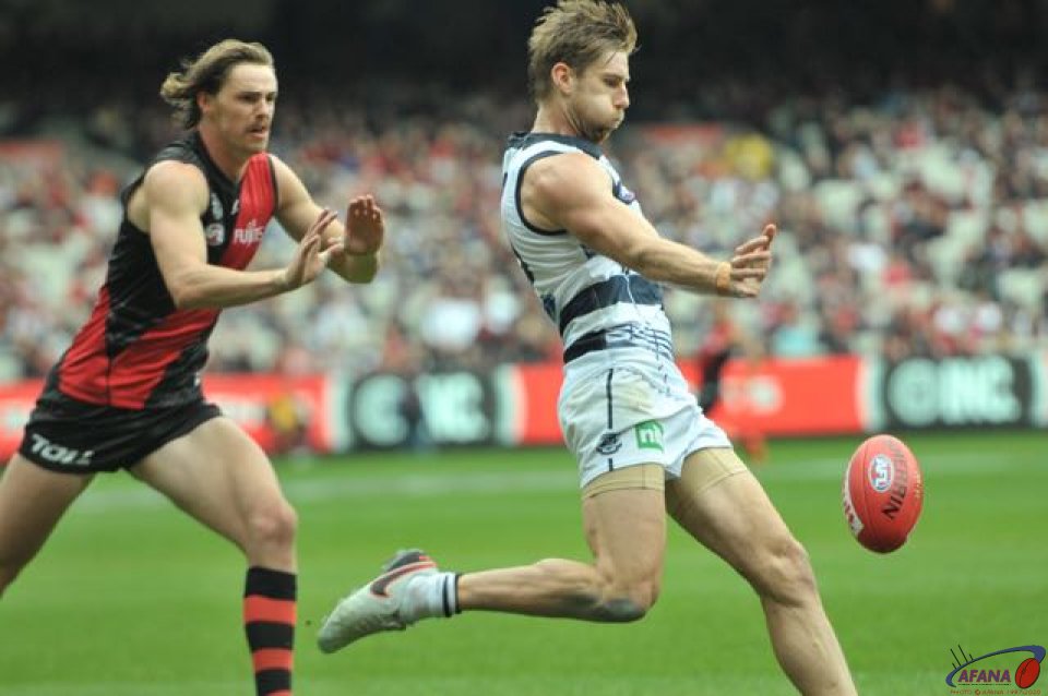 Tom Lonergan intercepts another ball in to Joe Daniher, who gives chase. 