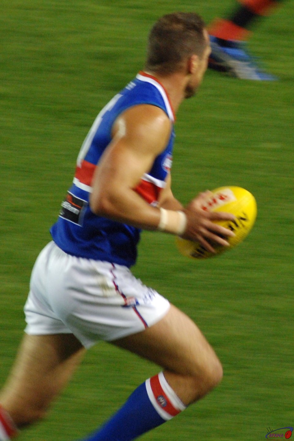Brad Johnson of the Western Bulldogs with the ball in his 300th game against Essendon