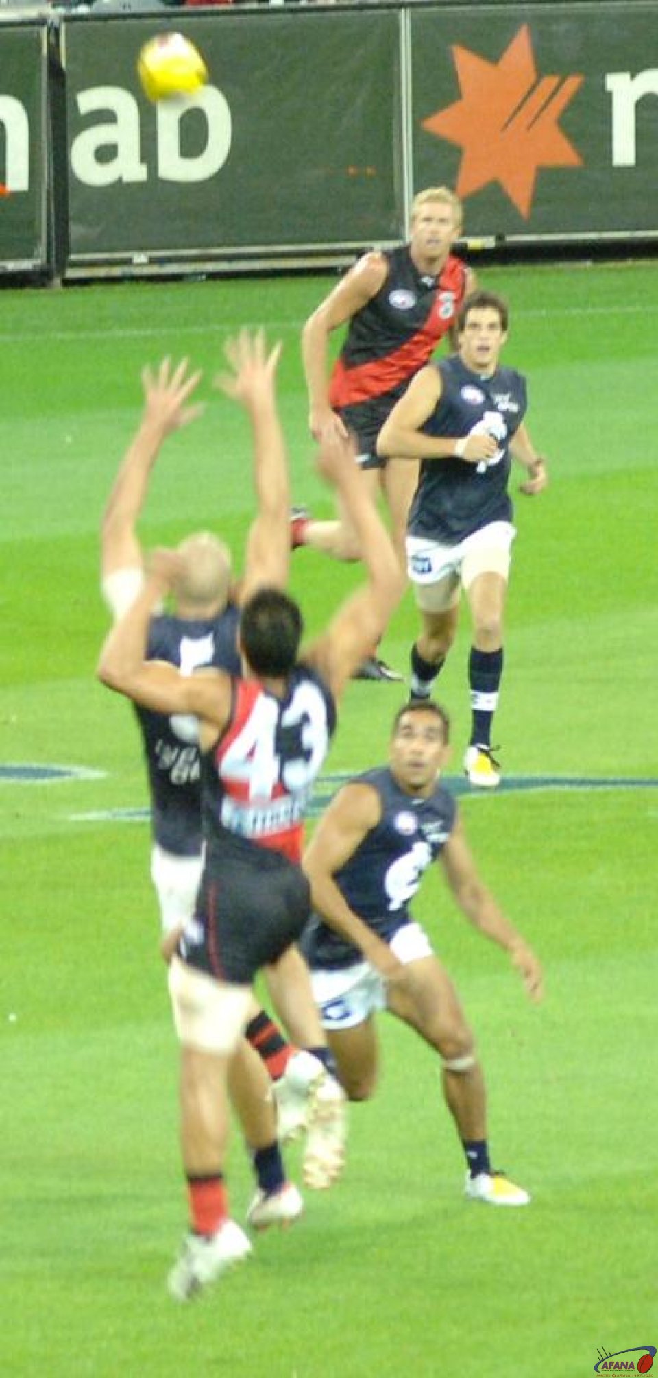 Mal Michael taking a mark for Essendon against Chris Judd of the Blues