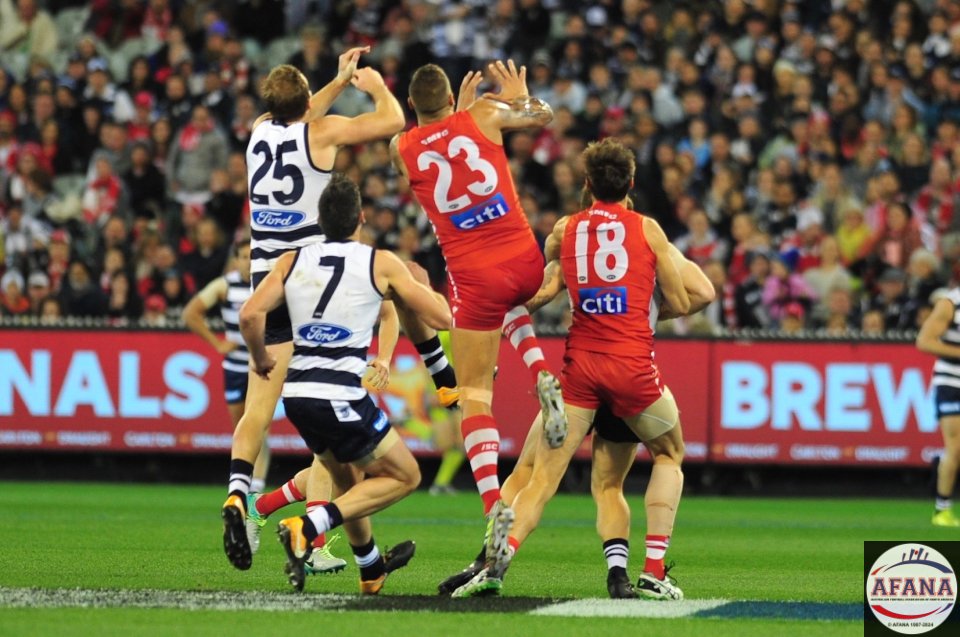 Buddy and Henderson contest an incoming ball into the Cats defence