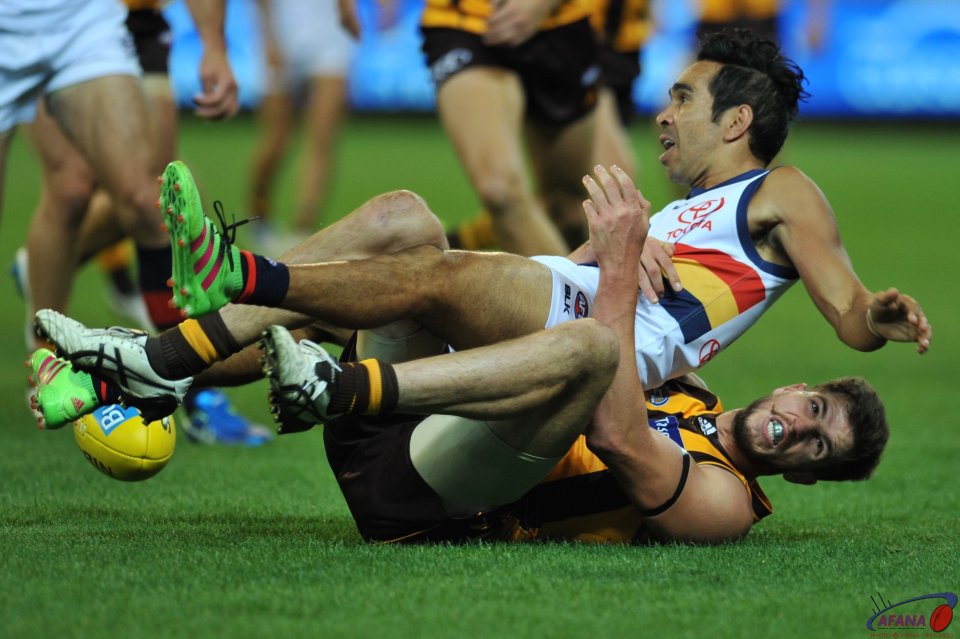 Ben Stratton rolls Eddie Betts in a tackle and the ball spills out