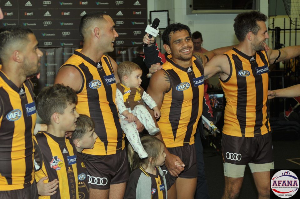 Bradley, Shaun with his kids, Cyril and Skipper Luke Hodge sing the victory song in the rooms