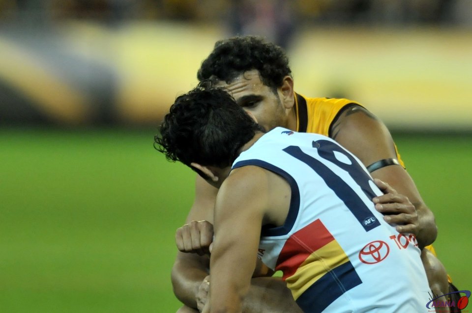 Cyril Rioli consoles Eddie Betts after an exciting Friday night at the G when the Hawks won by 3 points