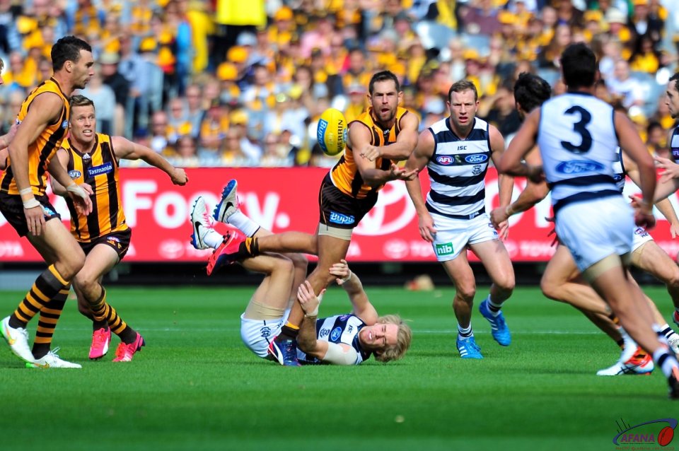 Luke Hodge barrels over Cameron Guthrie as he clears the midfield ball.