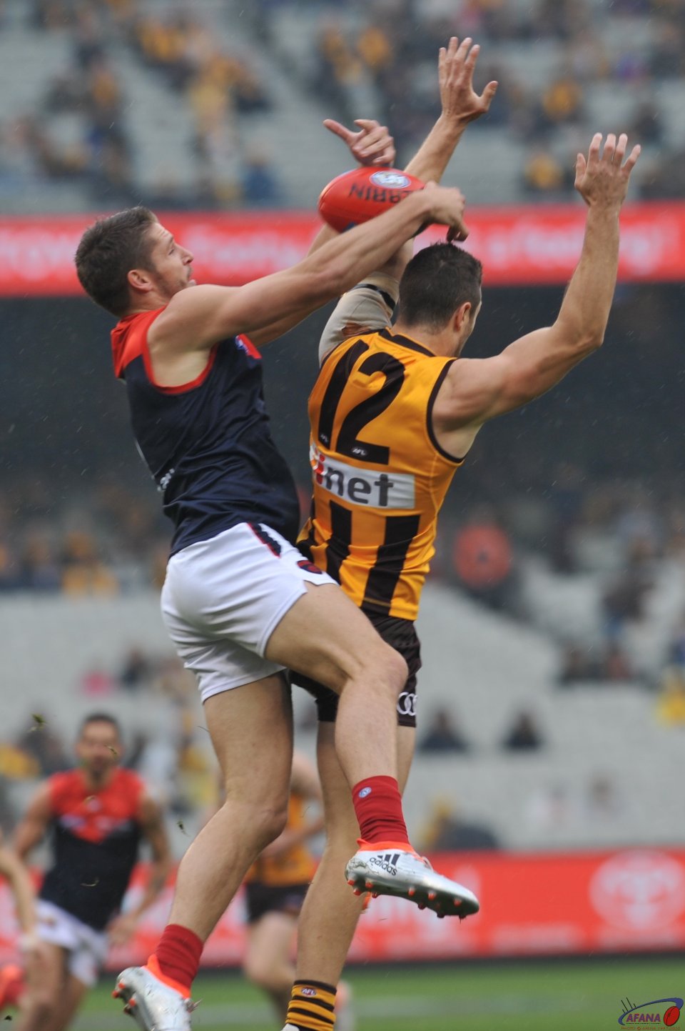 Jesse Hogan and James Frawley contest the incoming ball