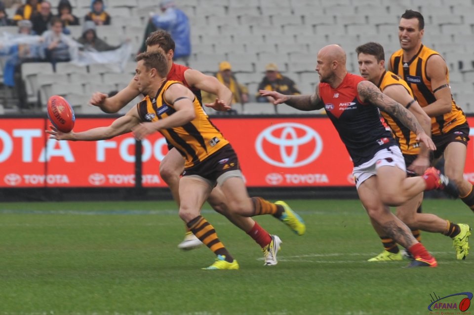 Sam Mitchell reaches for the ball as Nathan Jones prepares to tackle