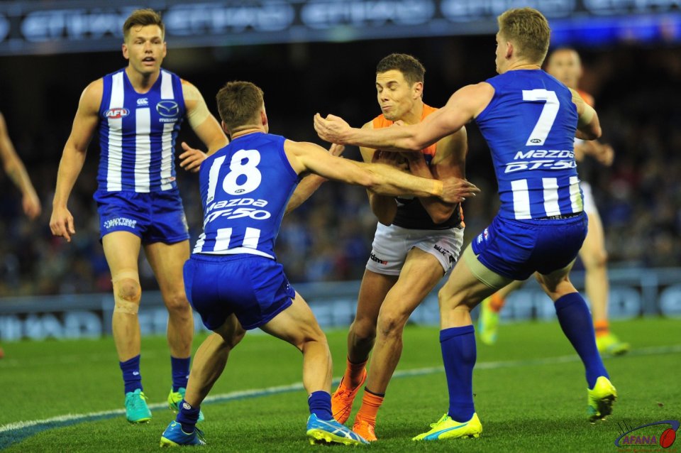Dylan Shiel runs into a North tackle as Jack Zeibell and Shaun Atley prepare to wrap him up