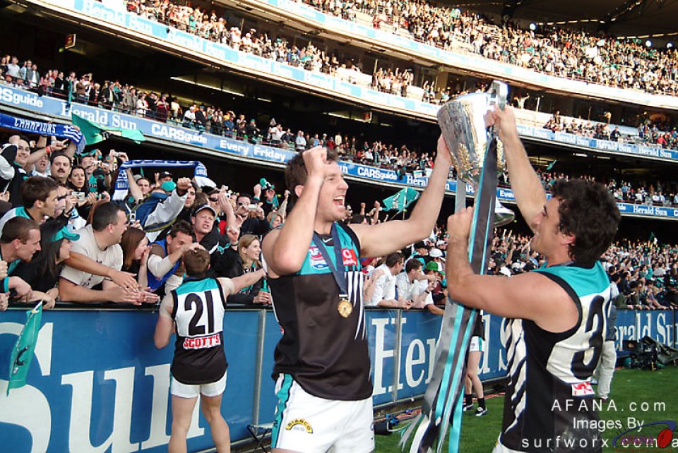 Brendan Lade and Roger James hoist the Premiership Cup.