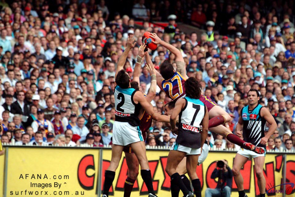 Clark Keating of Brisbane takes a mark high over a pack of players.