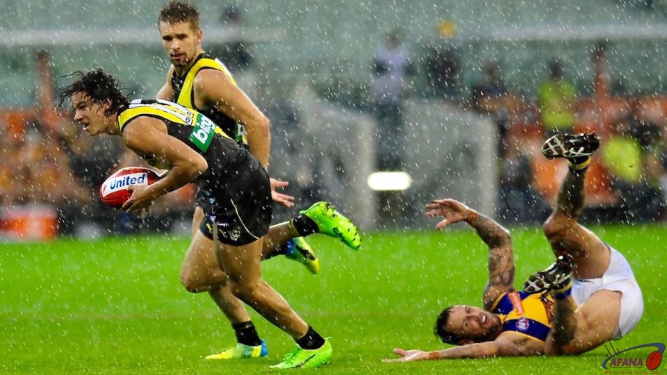Daniel Rioli swoops on the spilled ball as masten lies sprawled after the Ellis tackle