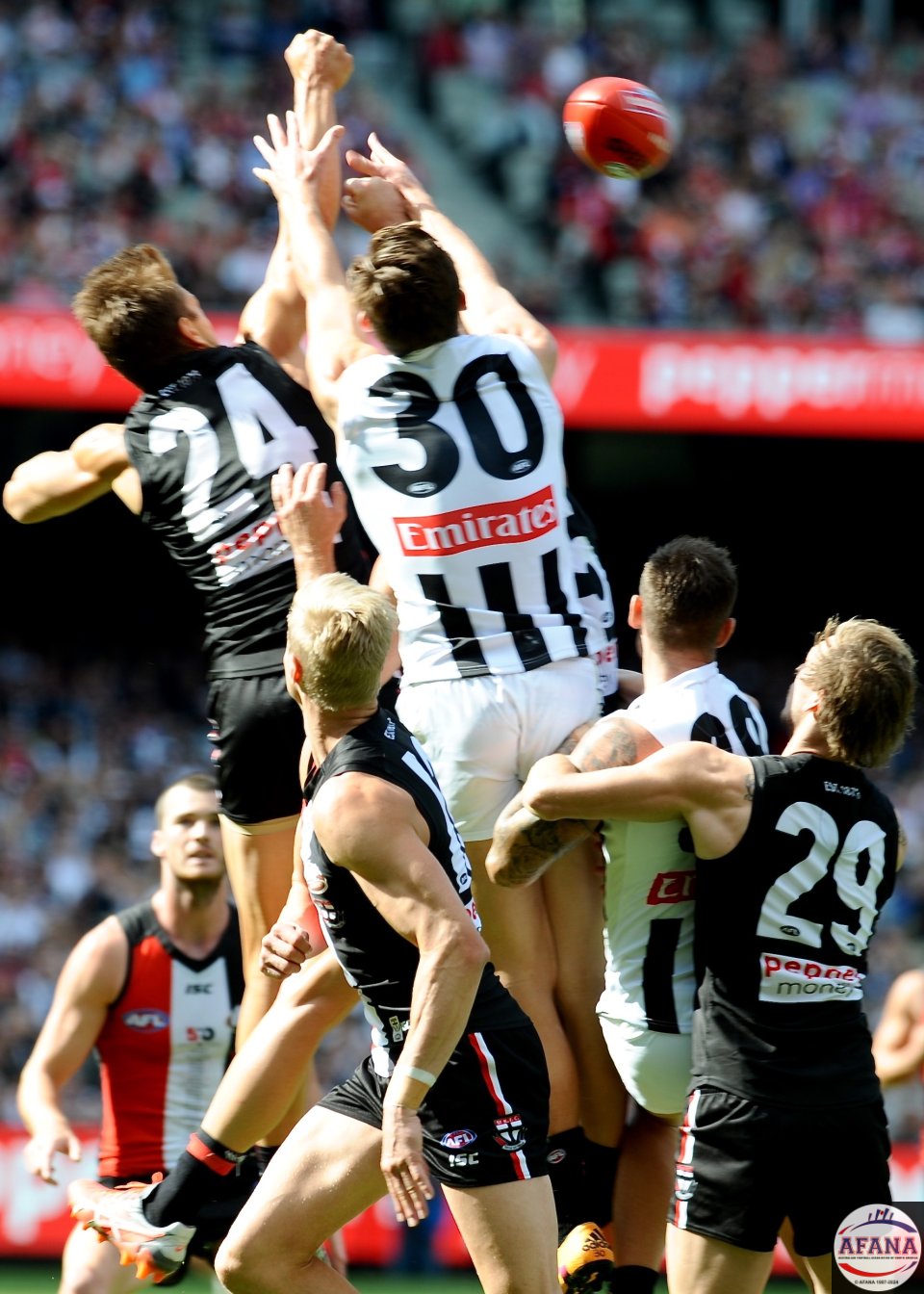 Sean Dempster punches the ball clear of Darcy Moore