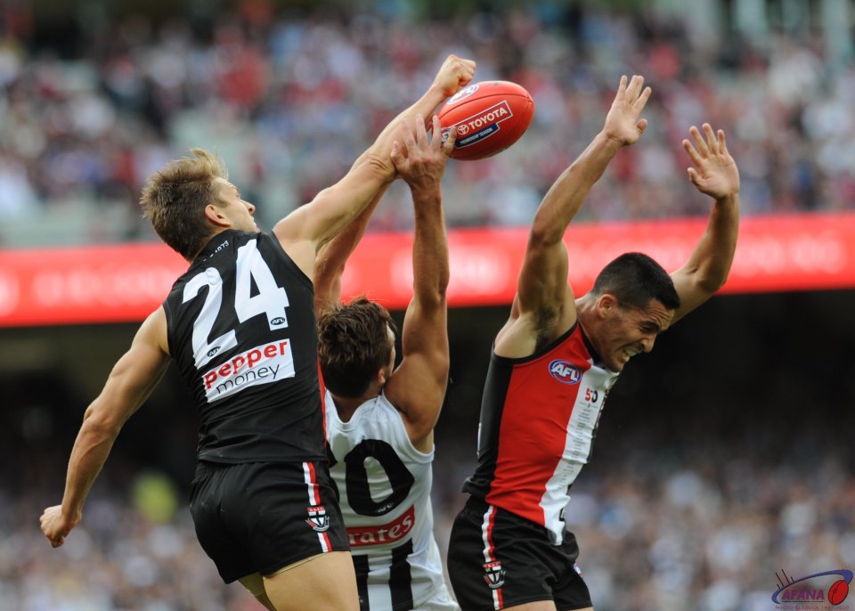 Sean Dempster spoils the long ball in as darcy Moore attempts a mark