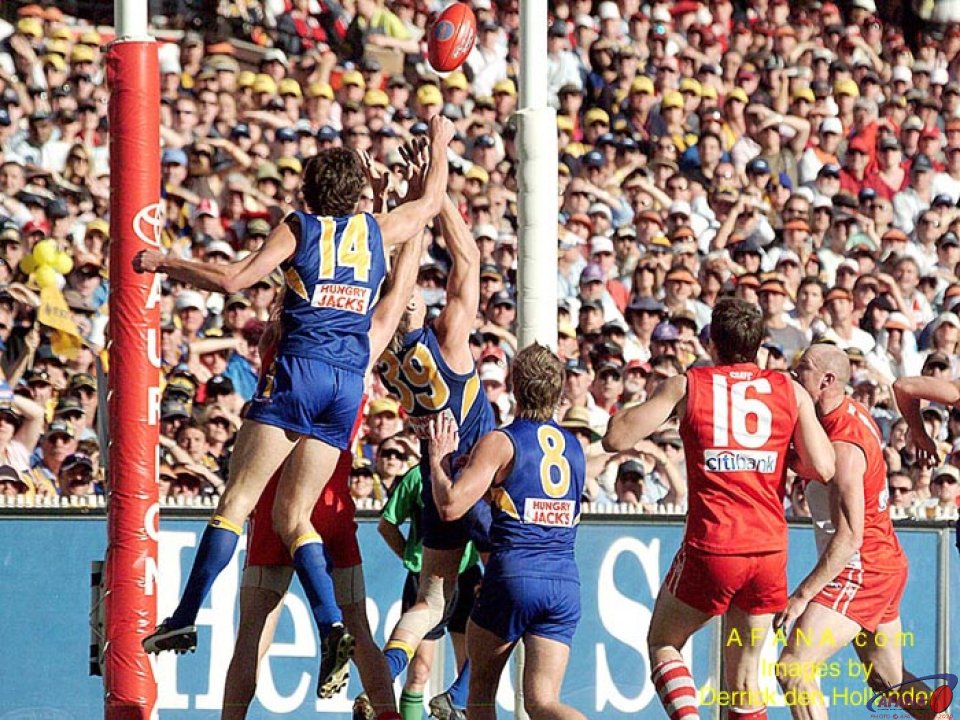 [b]A long kick in towards the goal scoring zone for the Sydney Swans is spoiled again by the disciplined West Coast defenders[/b