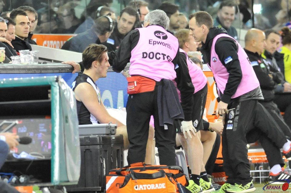 Docs attend to the graze aboce Darcy Moore's right eye