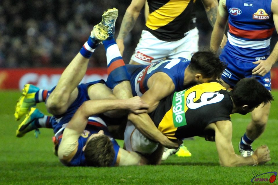 Trent Cotchin is double teamed by Matthew Boyd and Marcus Bontempelli