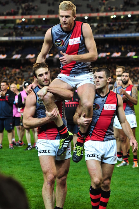 Dustin Fletcher is carried off by his captain Jobe Watson and Brent Stanton after playing his 400th game and becoming the third player in AFL history to do behind Michael Tuck and Kevin Bartlett. Photo by Kim Densham for AFANA.