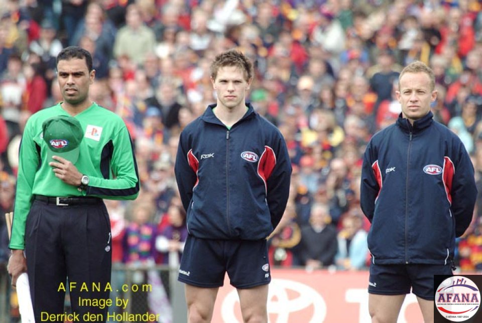 [b]Umpires for the game during the National Anthem at AAMI Stadium[/b]