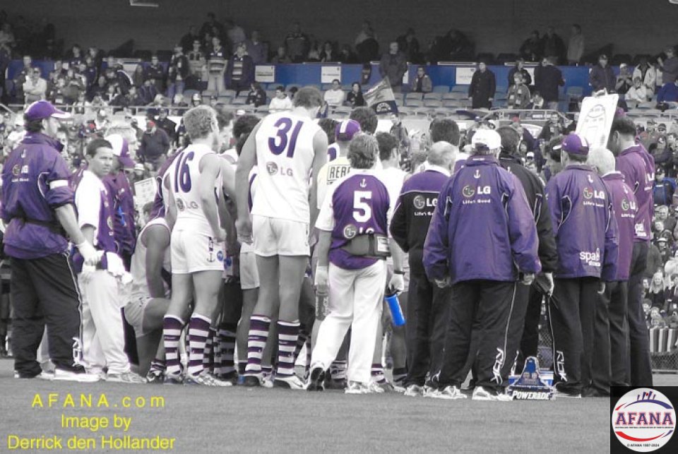 [b]The Fremantle Dockers, characterised in purple, are addressed by their coach before the second half of the game begins[/b]