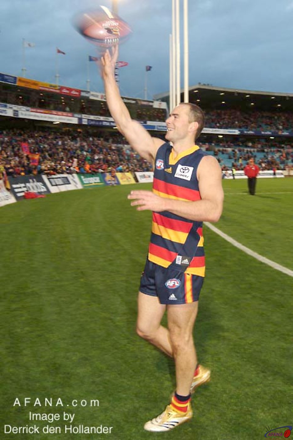 [b]Jason Torney illegally passes a souvenir ball to a member in the crowd after Adelaide's win[/b]