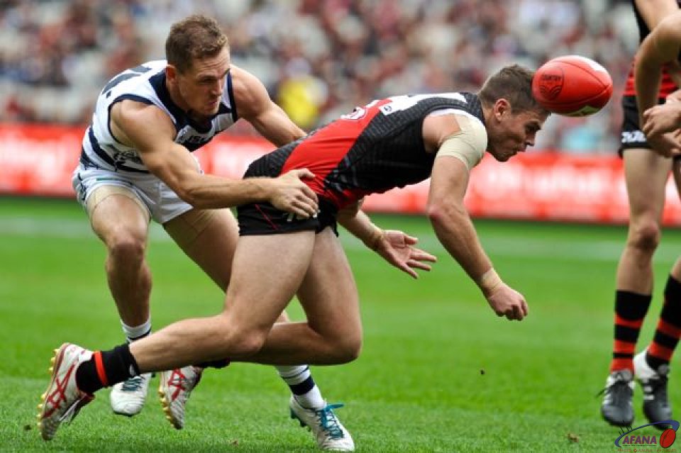 Cats skipper Joel Selwood spins Bomber Rookie Craig Bird in a tackle