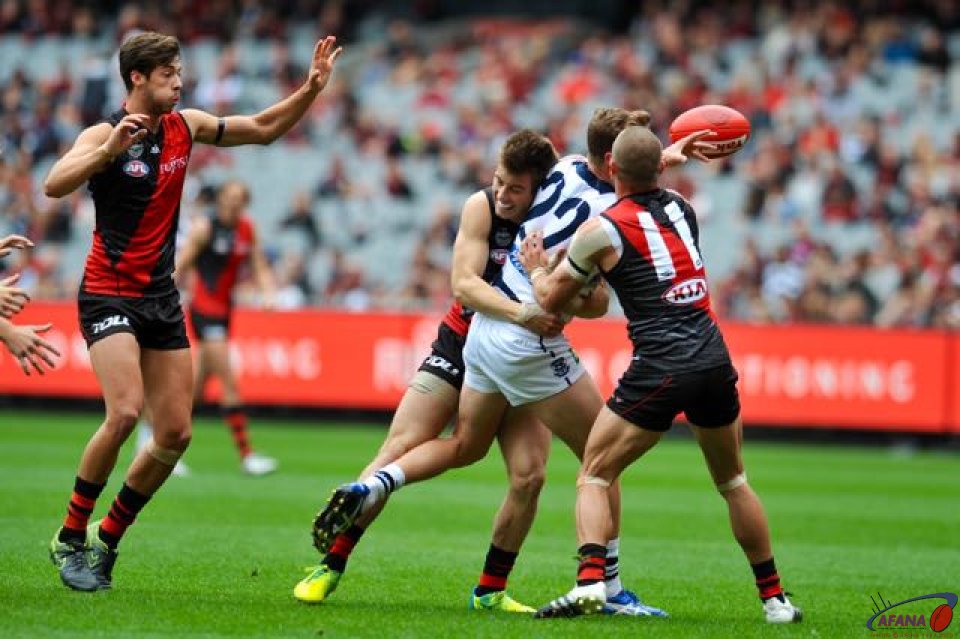 Mitch Duncan is double teamed by Essendon