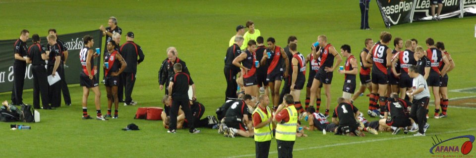 Essendon between the 3rd and 4th quarters catching a breatehr and getting coaching instructions.