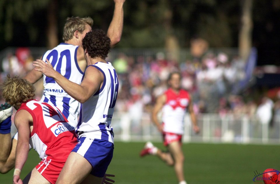 The Roo's Drew Petrie &amp;amp; David 
Trotter fight with the Swan's Kristin 
Thornton for the ball.