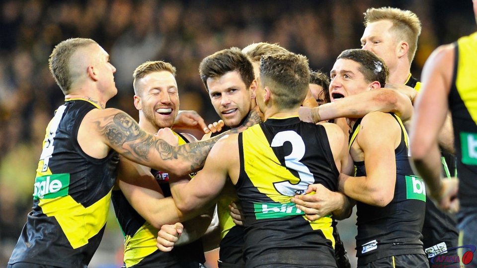 Tigers rush to congratulate Trent Cotchin on a captains goal