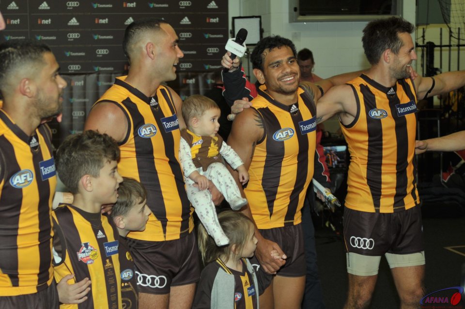 Bradley, Shaun with his kids, Cyril and Skipper Luke Hodge sing the victory song in the rooms