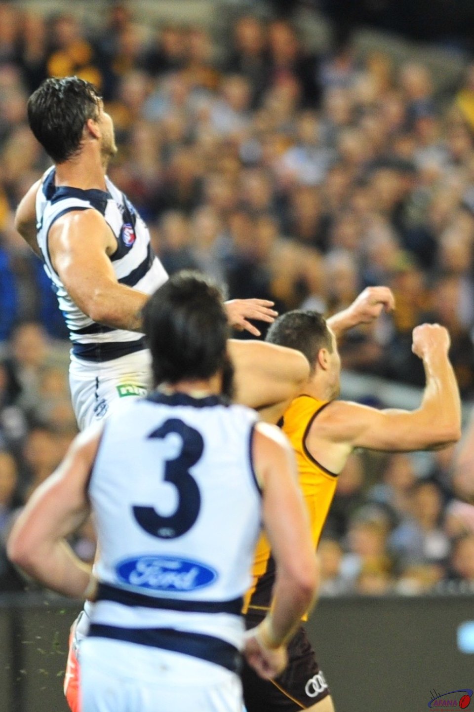 Tom Hawkins plants his knee into James Frawley as he gets air for a hanger