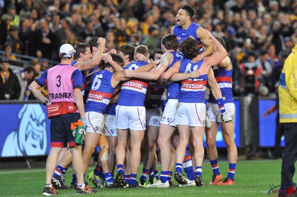 After the final siren the Dogs celebrate a win over the Hawks