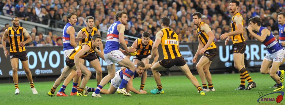 Jordan Roughead in heavy congestion has time to flick the handball out