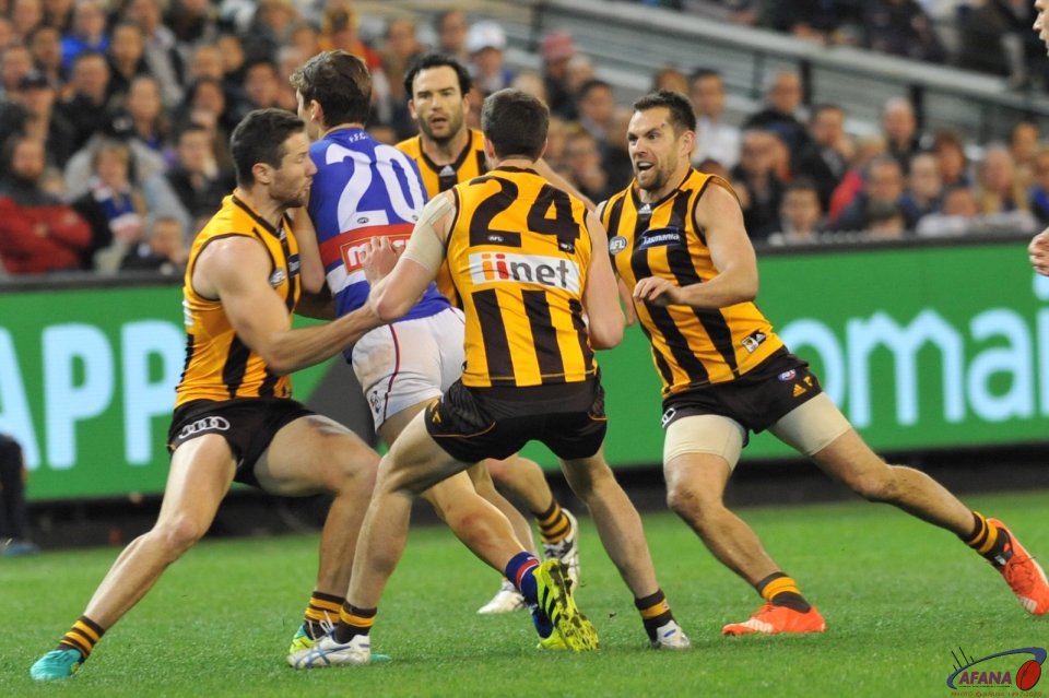 Josh Dunkley is gang tackled by James Frawley, Ben Stratton, Luke Hodge and Jordan Lewis