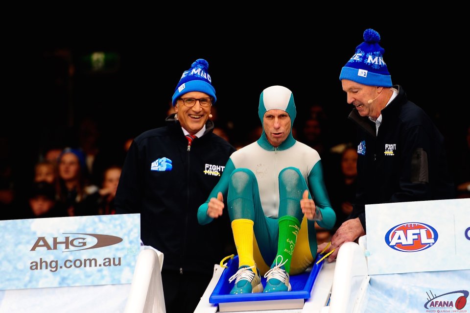 Steve Moneghetti dressed in Cathy Freeman's olympic gold medal outfit hits the ice bath