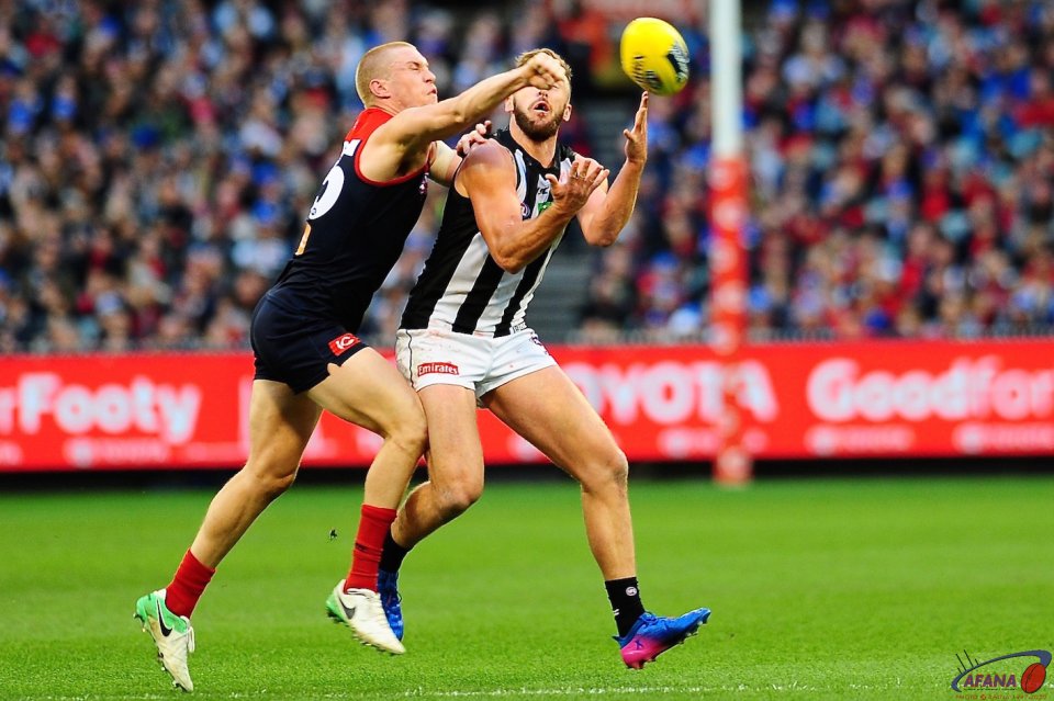 Tom McDonald gets a fist in to spoil the mark