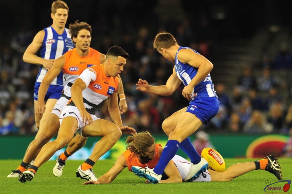 Callam ward on the ground as Dylan Shiel and Andrew Swallow look to gather the loose ball