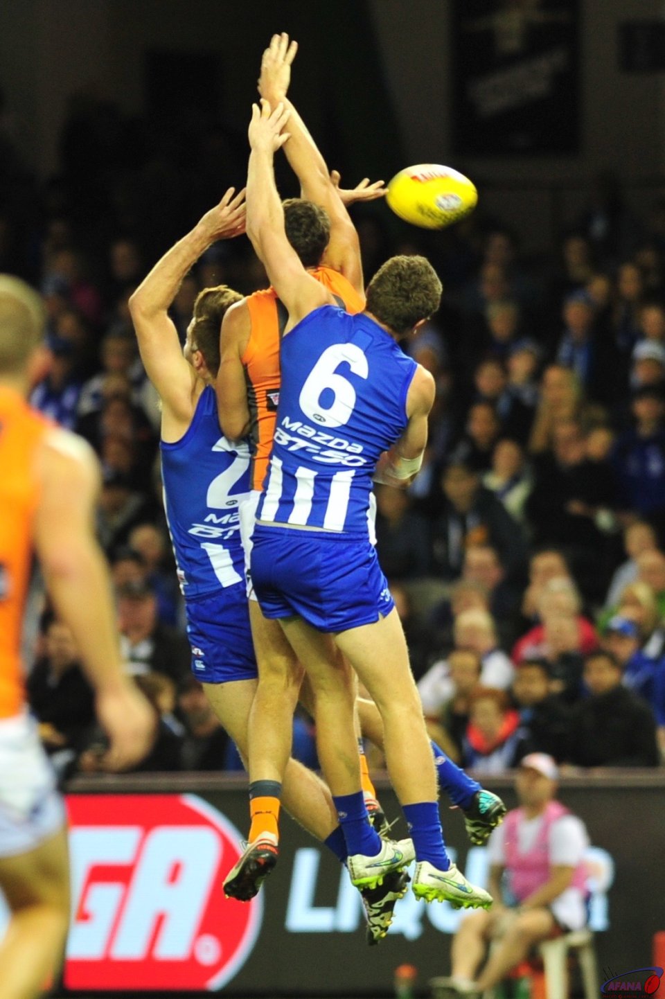 Jon Patton is double teamed by Lachie Hanson and Luke McDonald