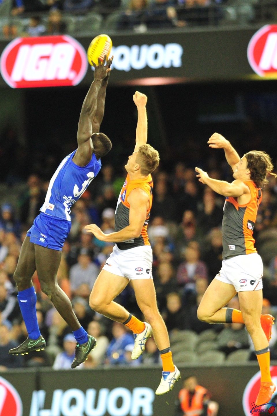 Majak Daw marks with great courage as the Giant's defenders close in for the spoil