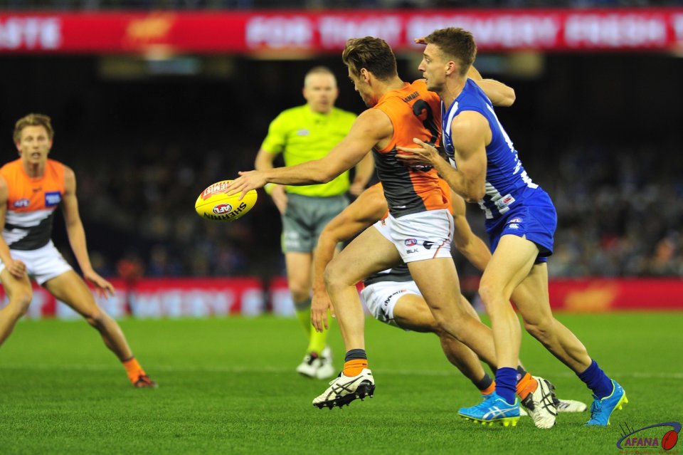 Stephen Coniglio clears the ball under pressure from Shaun Atley