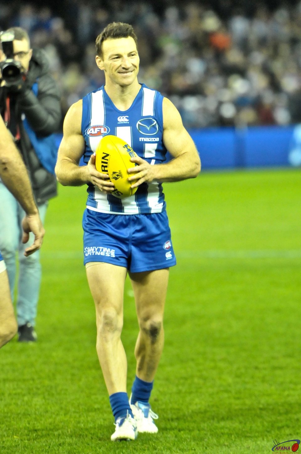 Brent Harvey leaves the field with a match ball afetr playing his 427th AFL:VFL game as the record holder for the most games